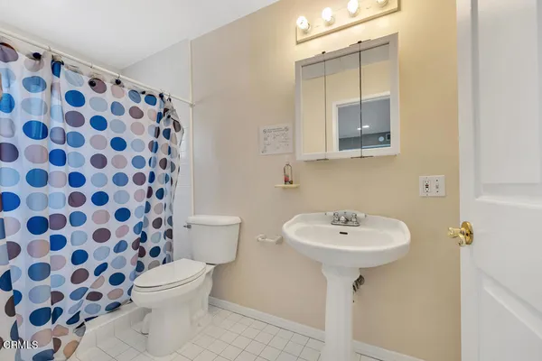 a bathroom with a sink toilet