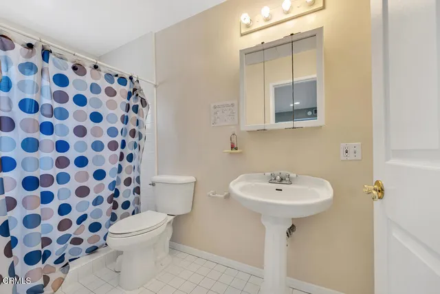 a bathroom with a sink toilet