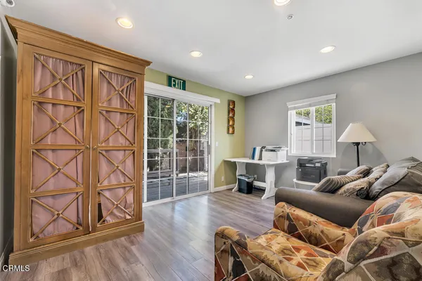 a living room with furniture a ceiling fan and a window