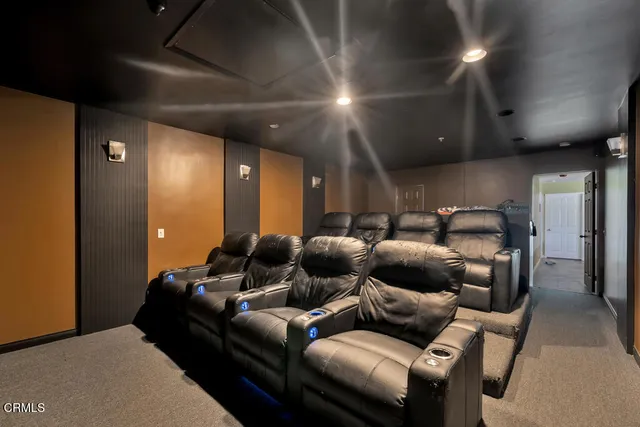 a media room with lots of chairs and a projector