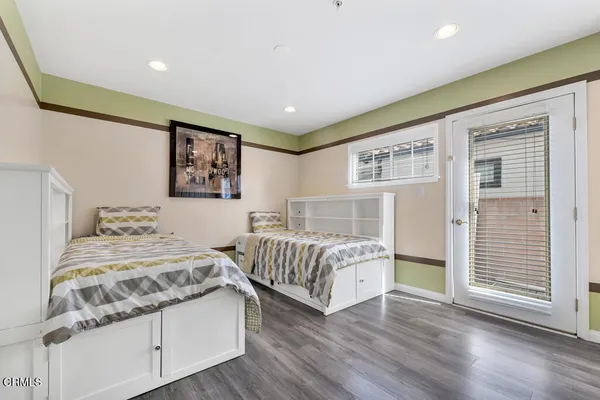 a spacious bedroom with two beds and a large window