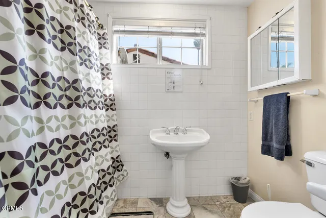 a bathroom with a sink toilet and mirror