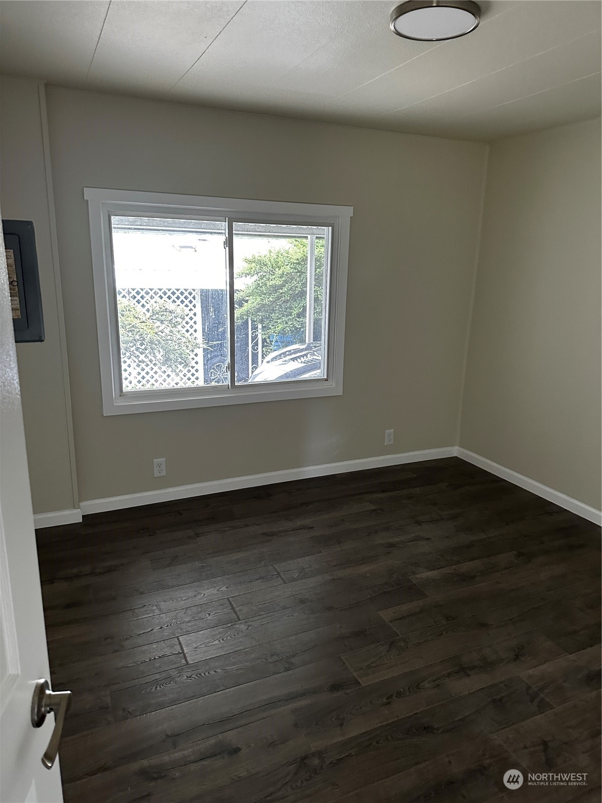 201 Union Avenue Southeast, Unit 90 Renton, WA 98059 - Photo 14 of 22 an empty room with wooden floor and windows