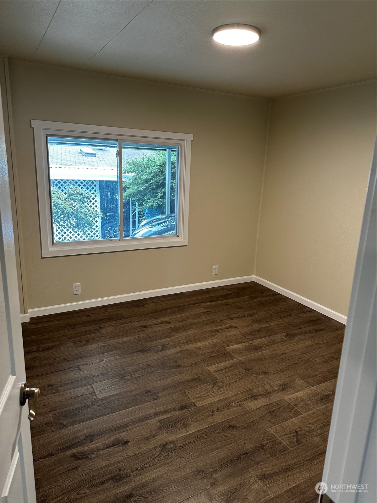 201 Union Avenue Southeast, Unit 90 Renton, WA 98059 - Photo 19 of 22 an empty room with wooden floor and windows