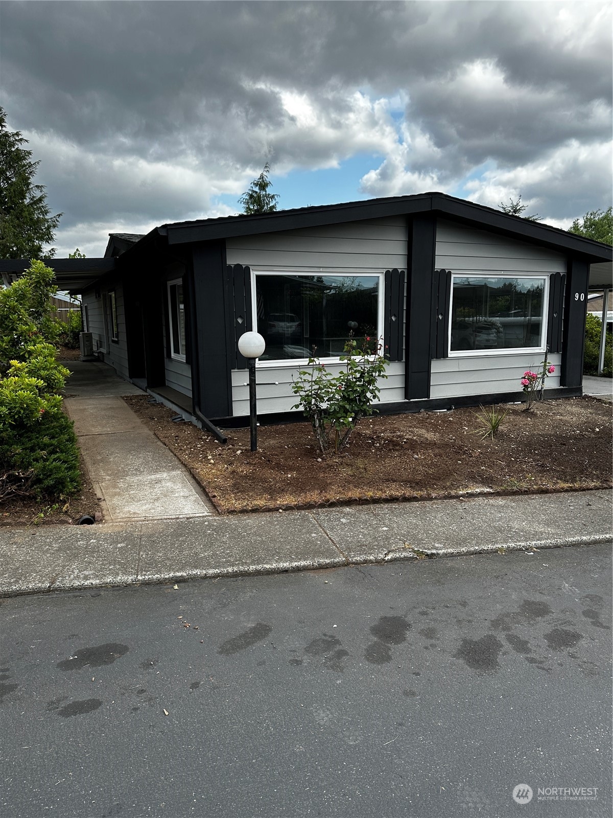 201 Union Avenue Southeast, Unit 90 Renton, WA 98059 - Photo 22 of 22 a front view of a house with a yard and a garage