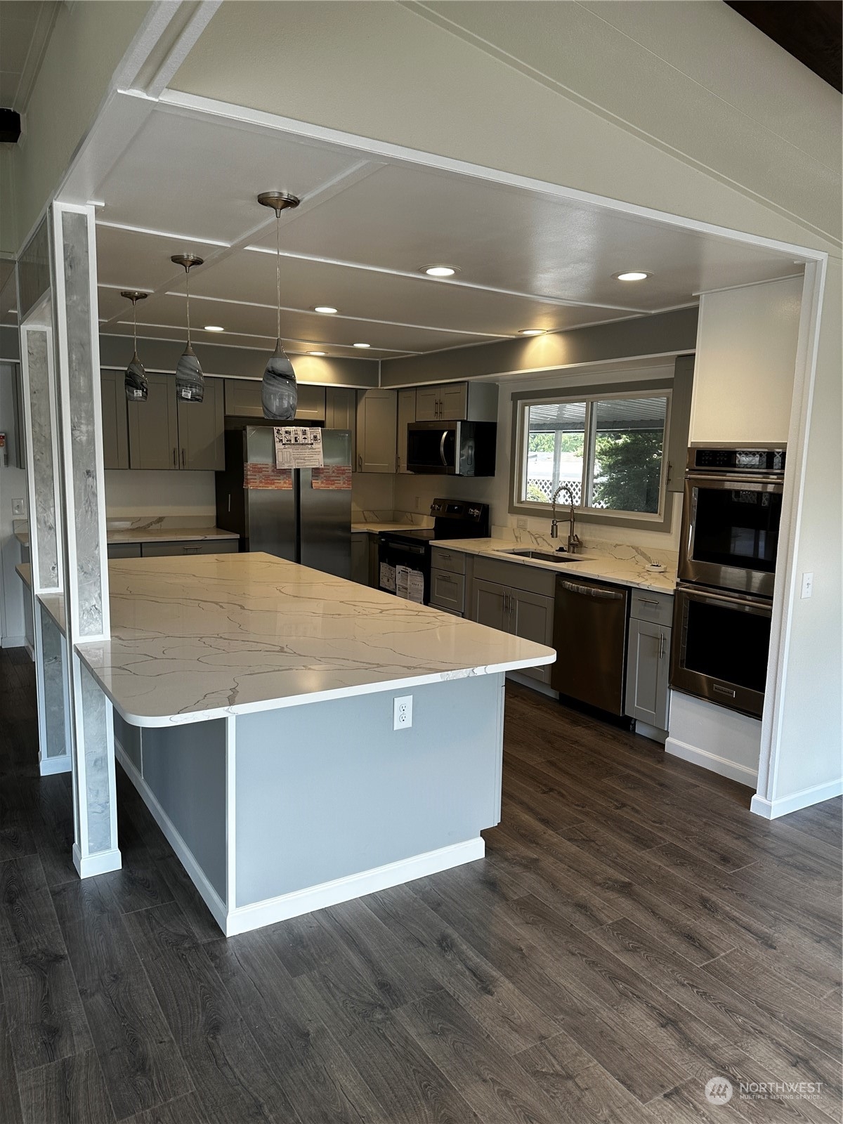 201 Union Avenue Southeast, Unit 90 Renton, WA 98059 - Photo 6 of 22 a view of kitchen with stainless steel appliances wooden floor dining table and chairs