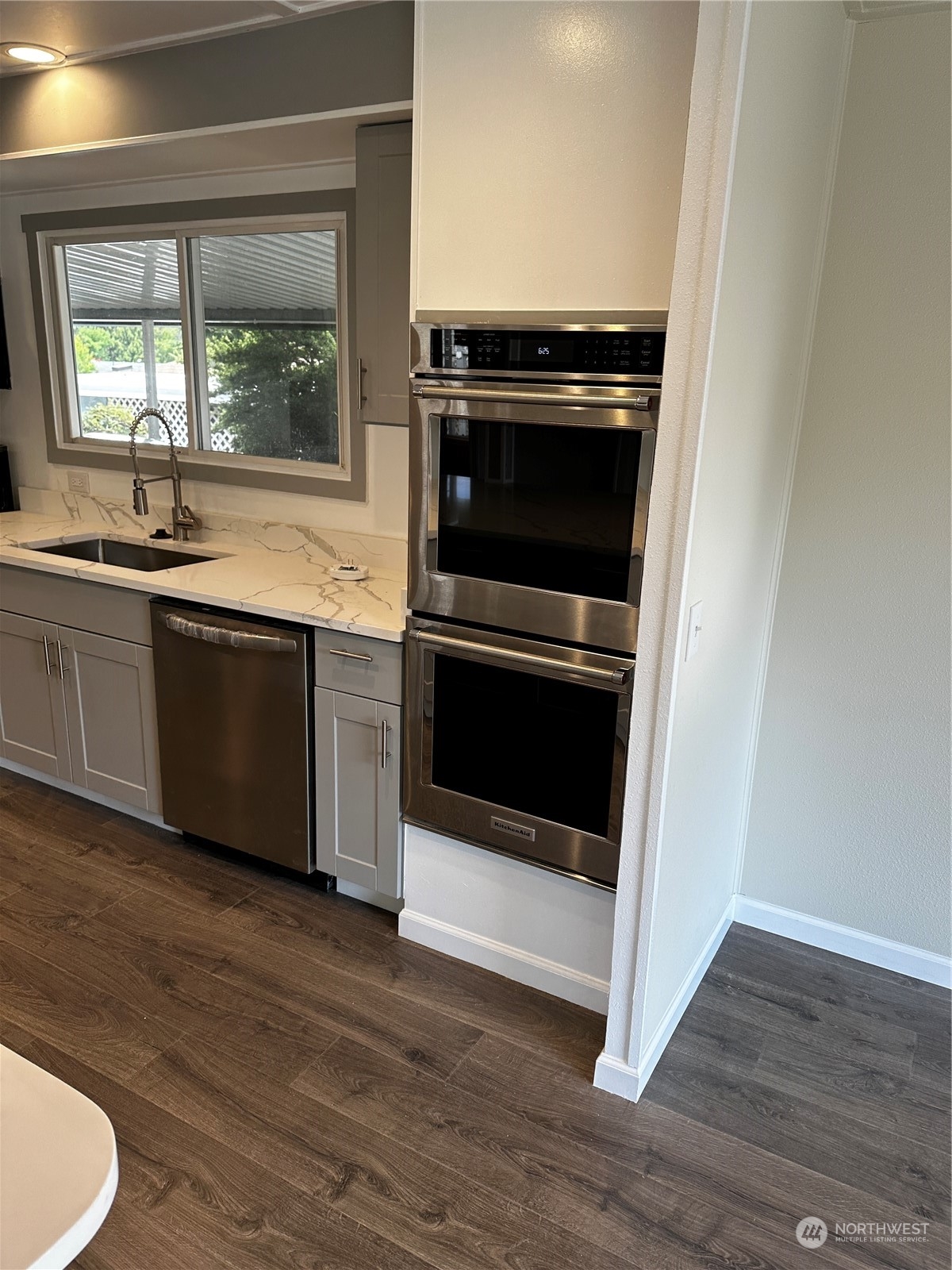 201 Union Avenue Southeast, Unit 90 Renton, WA 98059 - Photo 7 of 22 a kitchen with a sink and a microwave
