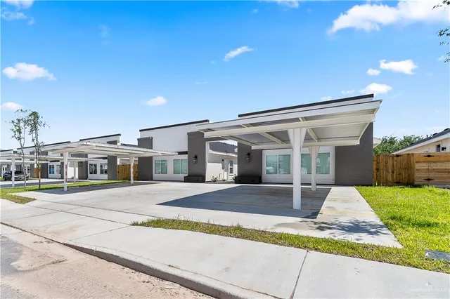 a front view of a house with a yard and table and chairs