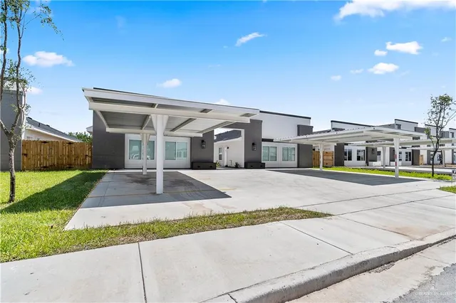 a front view of a house with a yard and table and chairs