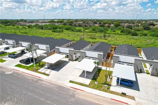 an aerial view of a house with garden space and street view