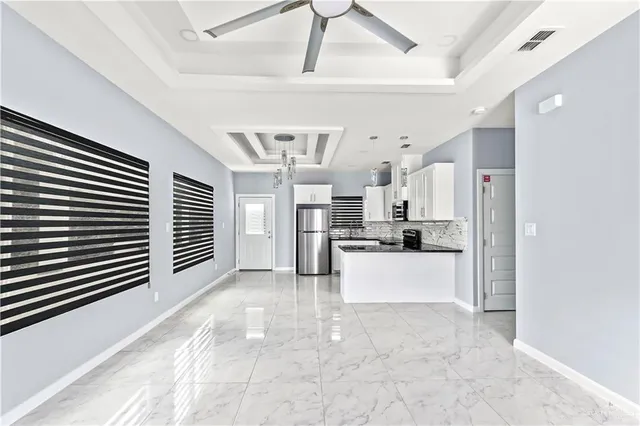 a view of a kitchen with refrigerator and windows