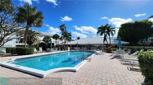 a view of a swimming pool with chairs