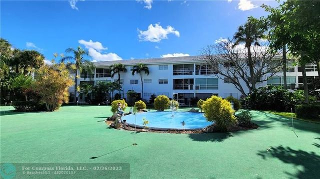 a front view of a house with a yard and outdoor seating