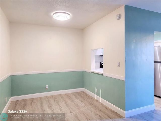 a view of a room with wooden floor