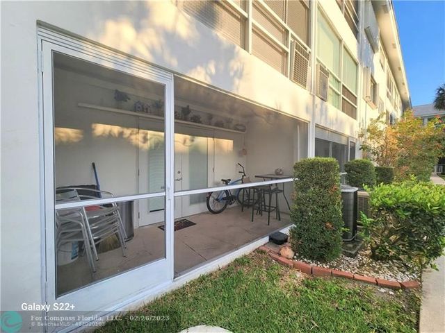 a view of a backyard with sitting area and garden