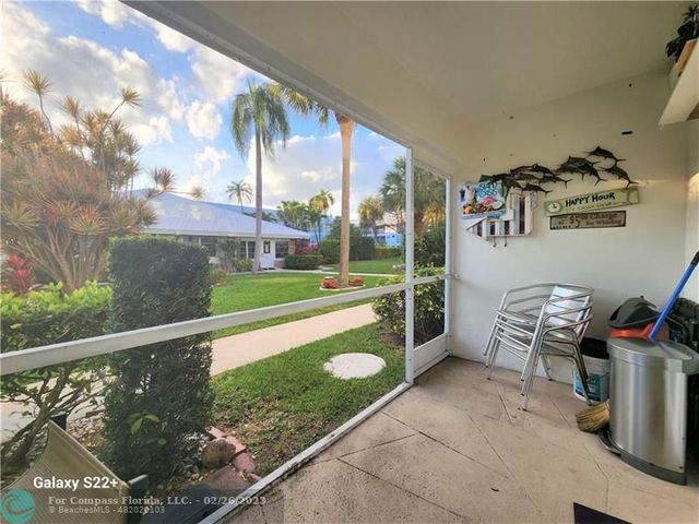 a view of a porch with furniture and garden