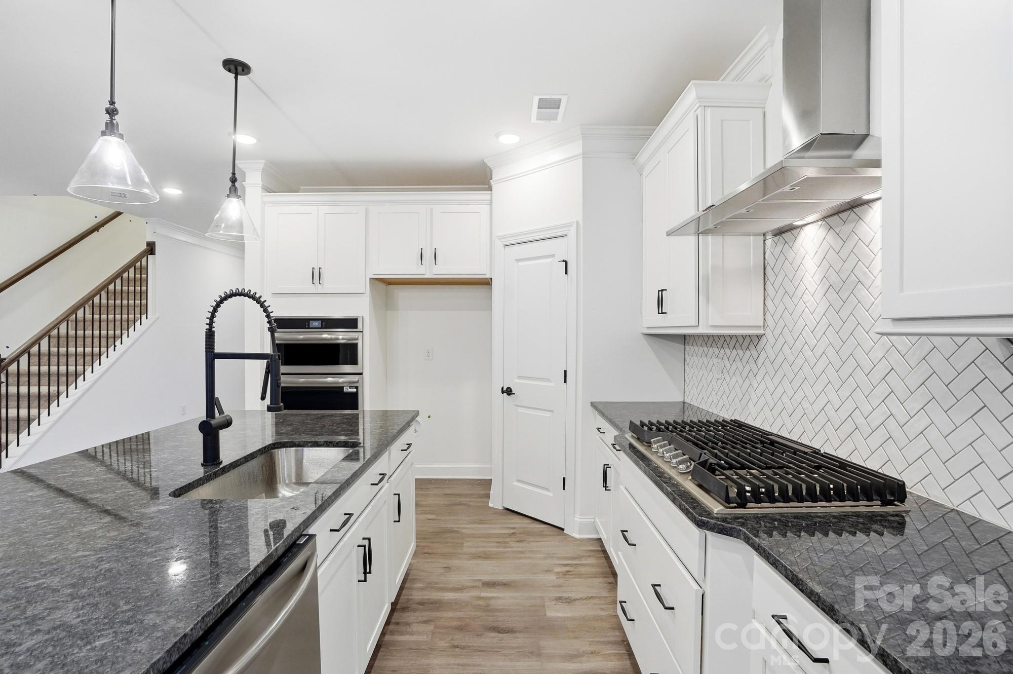 5072 Mclaughlin Loop Waxhaw, NC 28173 - Photo 11 of 46 a kitchen with stainless steel appliances granite countertop a sink a stove and a refrigerator
