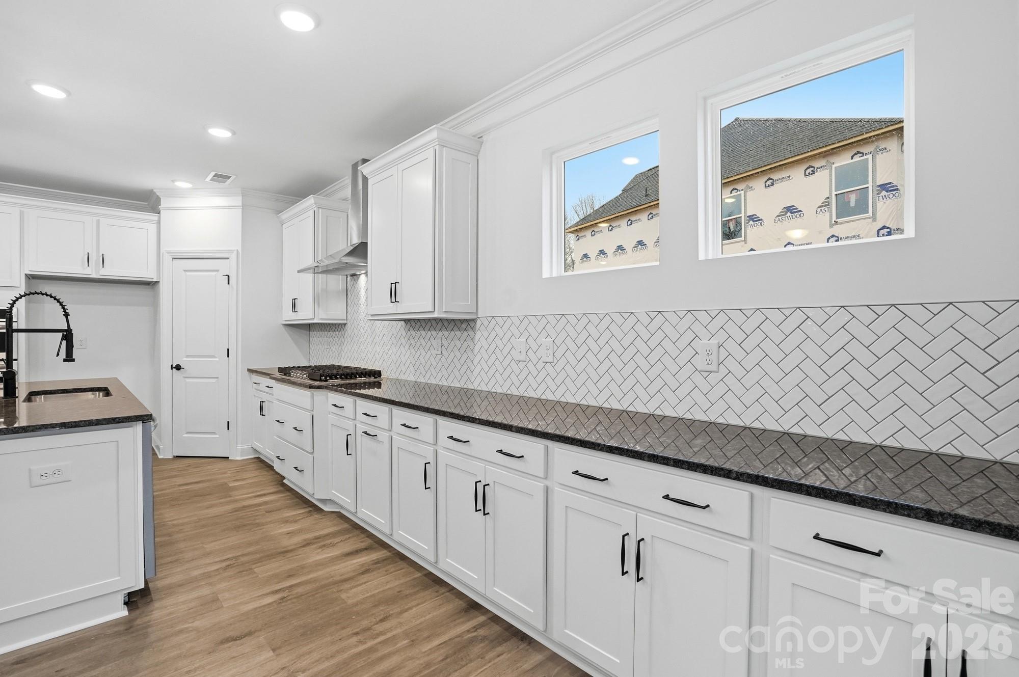5072 Mclaughlin Loop Waxhaw, NC 28173 - Photo 14 of 46 a kitchen with granite countertop white cabinets and white appliances