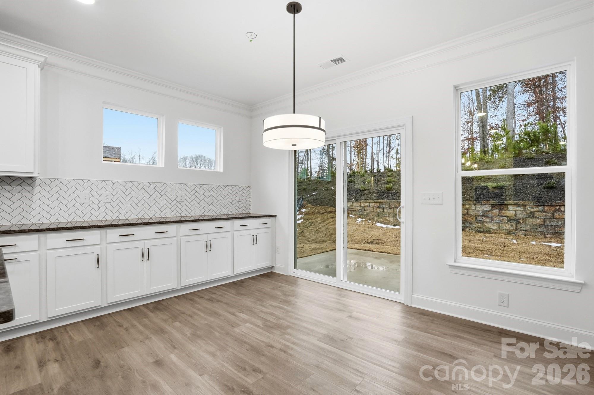 5072 Mclaughlin Loop Waxhaw, NC 28173 - Photo 15 of 46 a kitchen with window wooden floor and white appliances