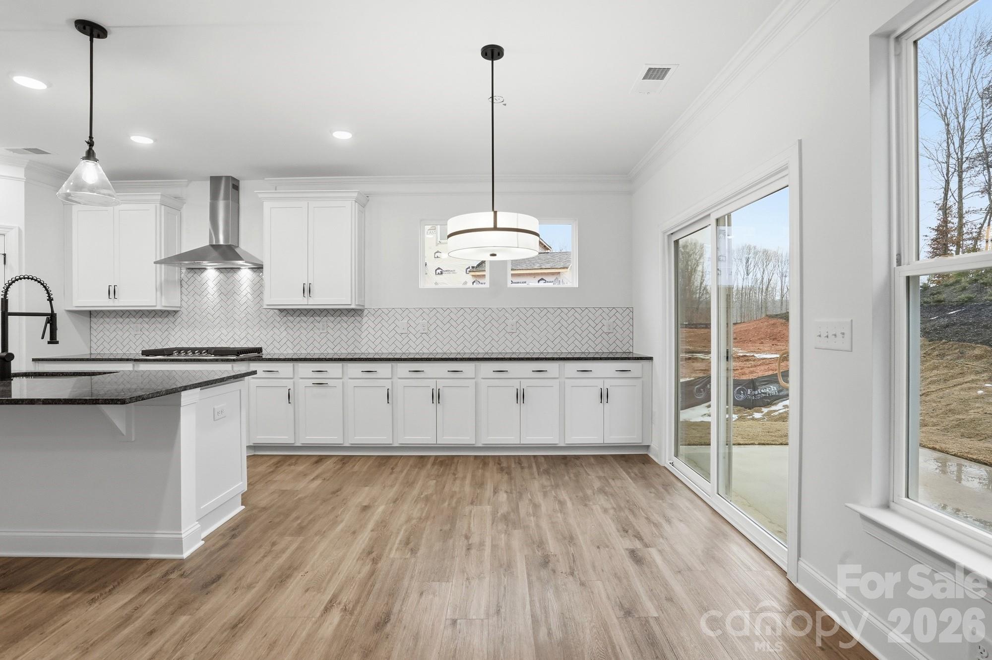 5072 Mclaughlin Loop Waxhaw, NC 28173 - Photo 16 of 46 a view of a kitchen with wooden floor and a sink