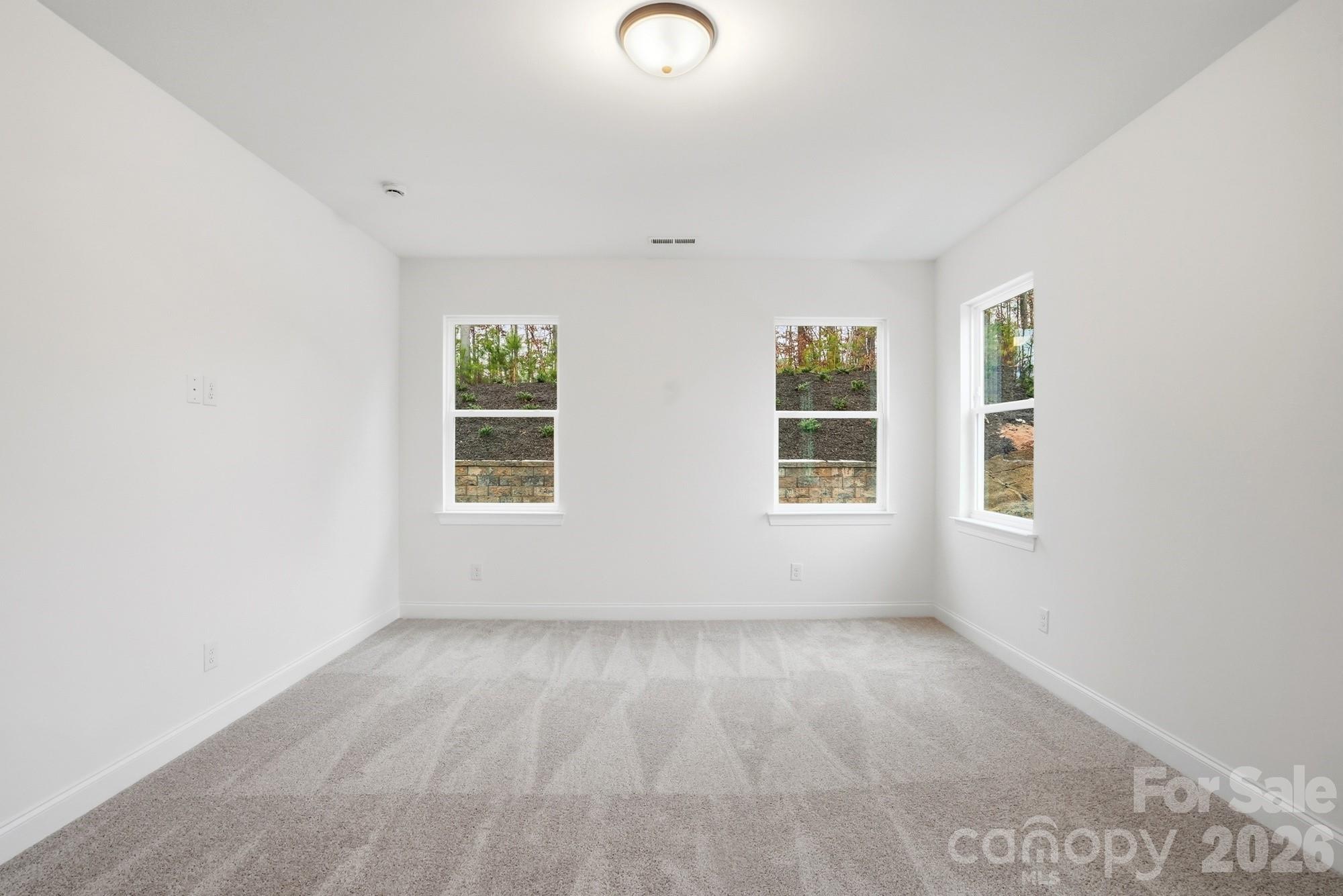 5072 Mclaughlin Loop Waxhaw, NC 28173 - Photo 17 of 46 an empty room with windows