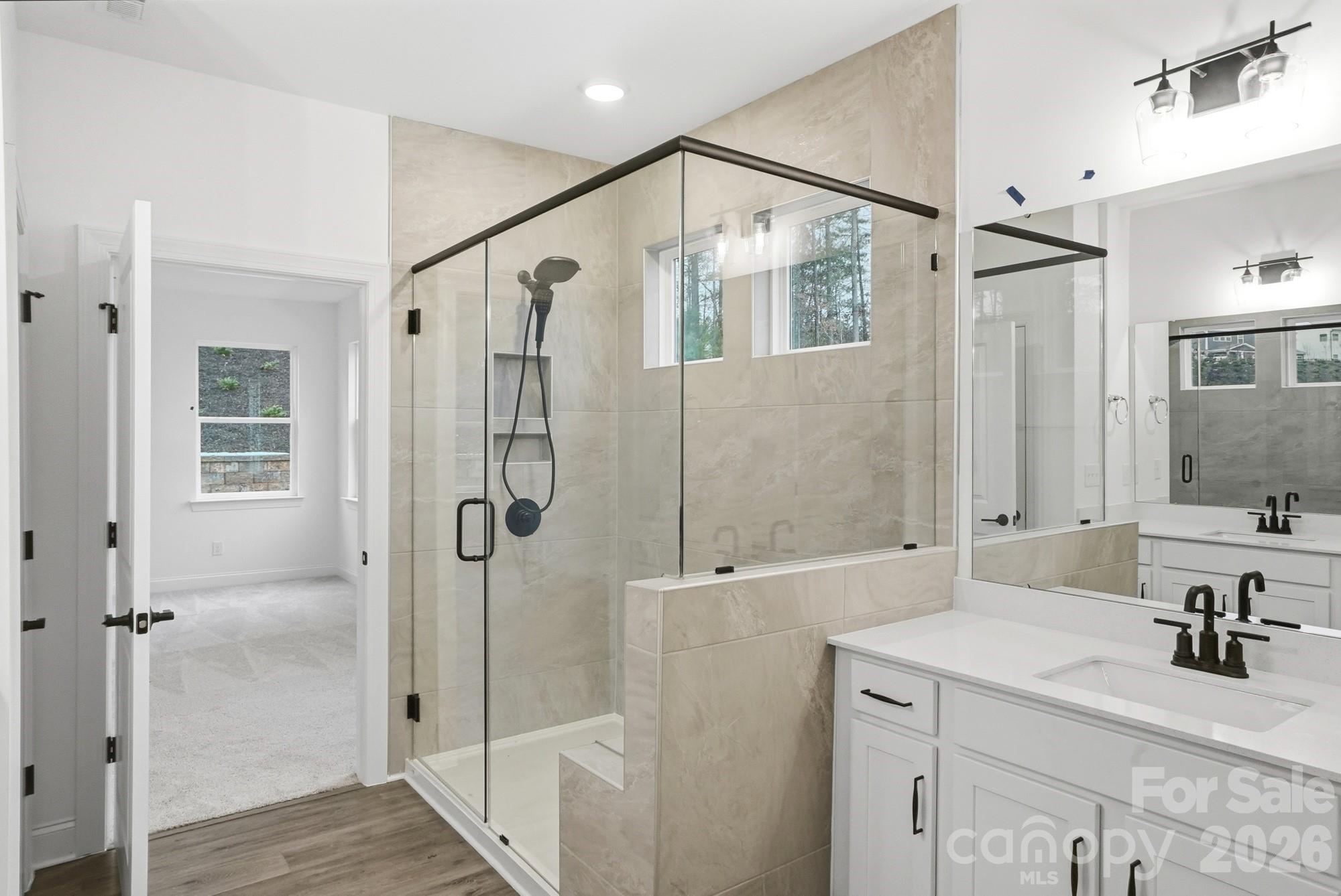 5072 Mclaughlin Loop Waxhaw, NC 28173 - Photo 24 of 46 a bathroom with a shower sink and mirror