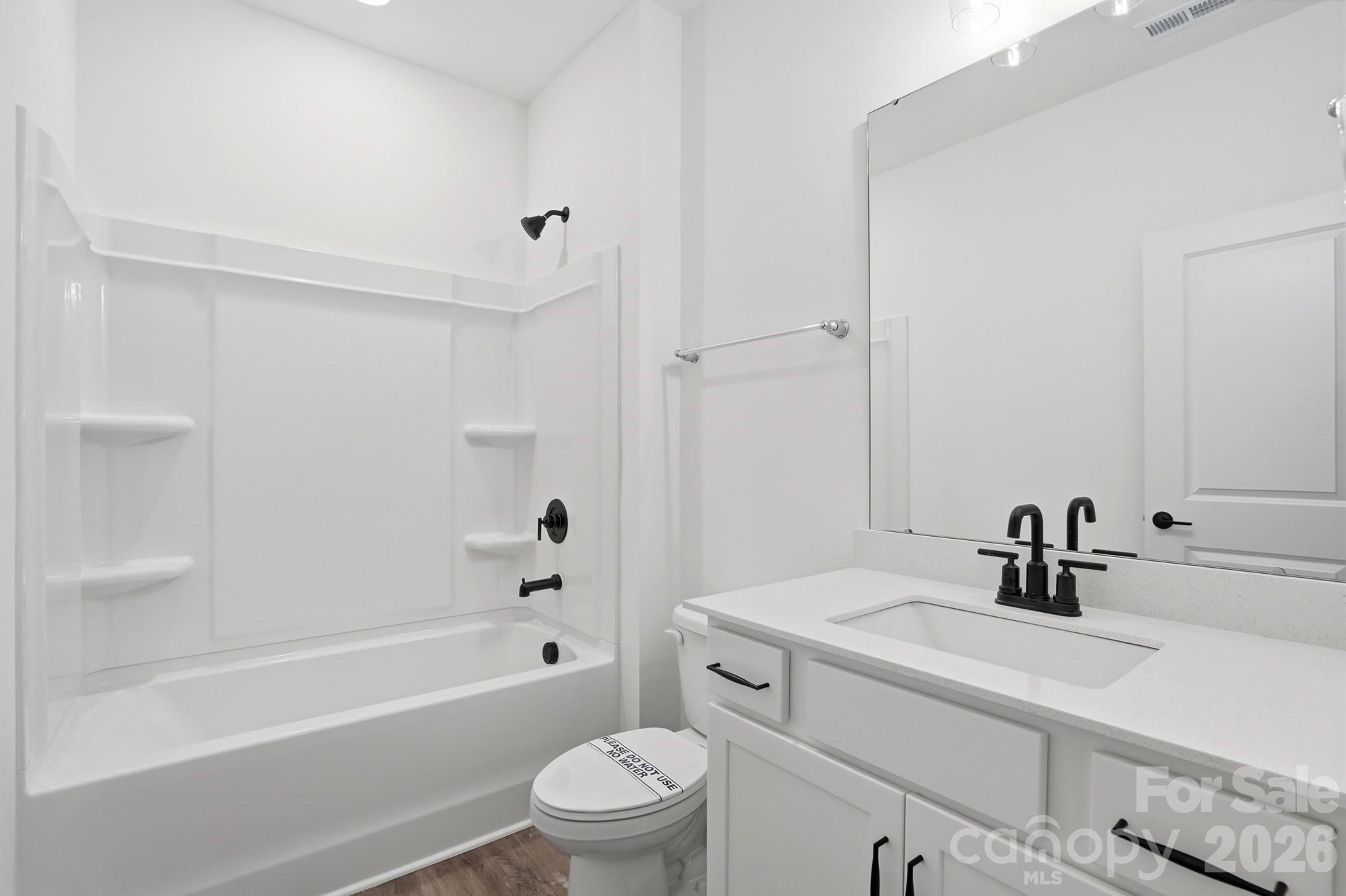5072 Mclaughlin Loop Waxhaw, NC 28173 - Photo 29 of 46 a bathroom with a sink a toilet and shower