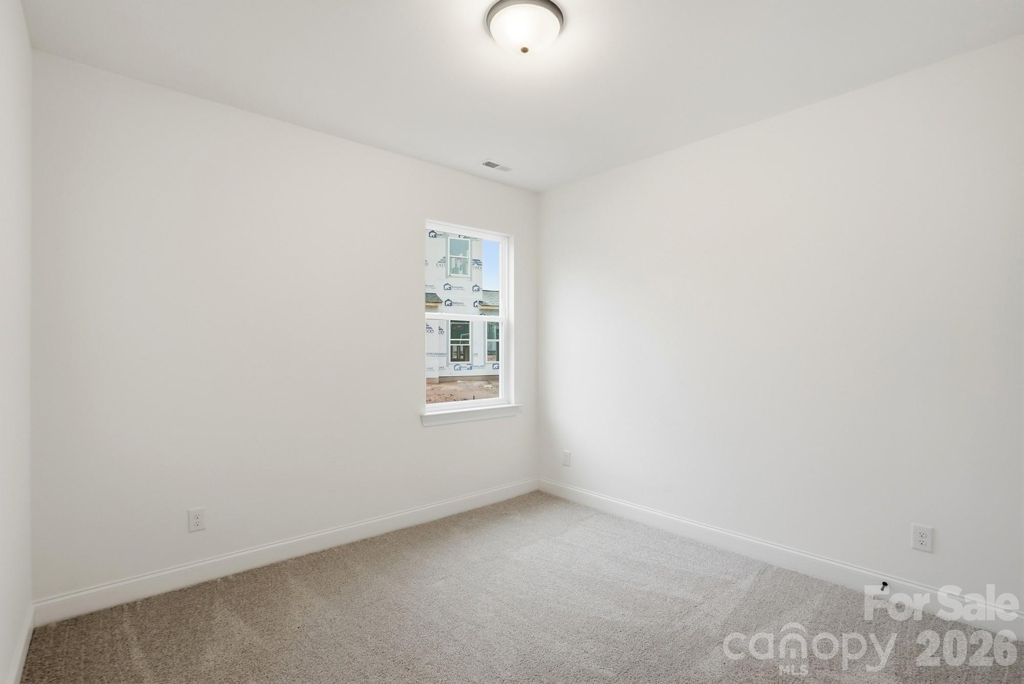 5072 Mclaughlin Loop Waxhaw, NC 28173 - Photo 30 of 46 a view of an empty room with a window