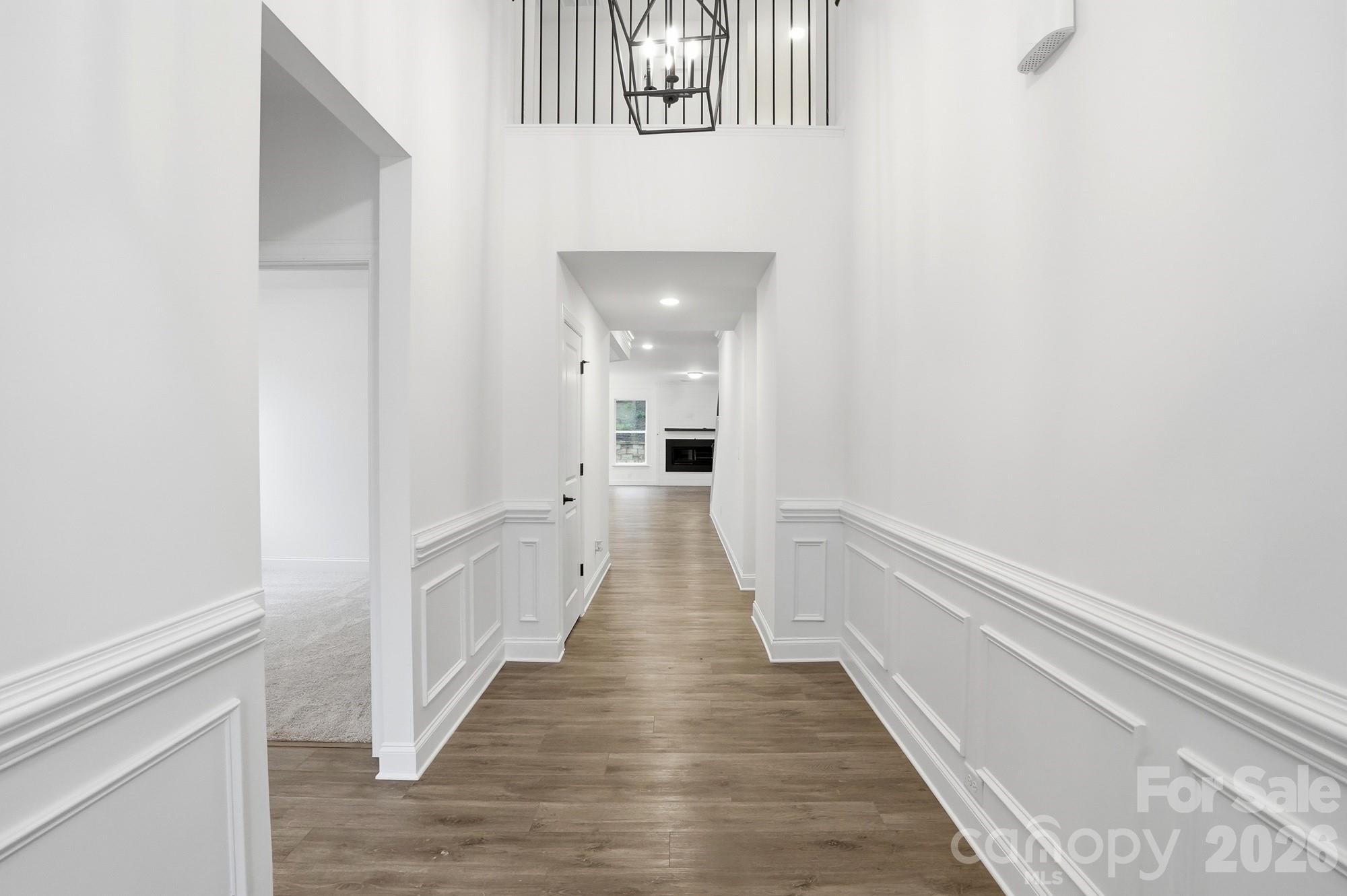 5072 Mclaughlin Loop Waxhaw, NC 28173 - Photo 4 of 46 a view of a hallway with wooden floor and staircase
