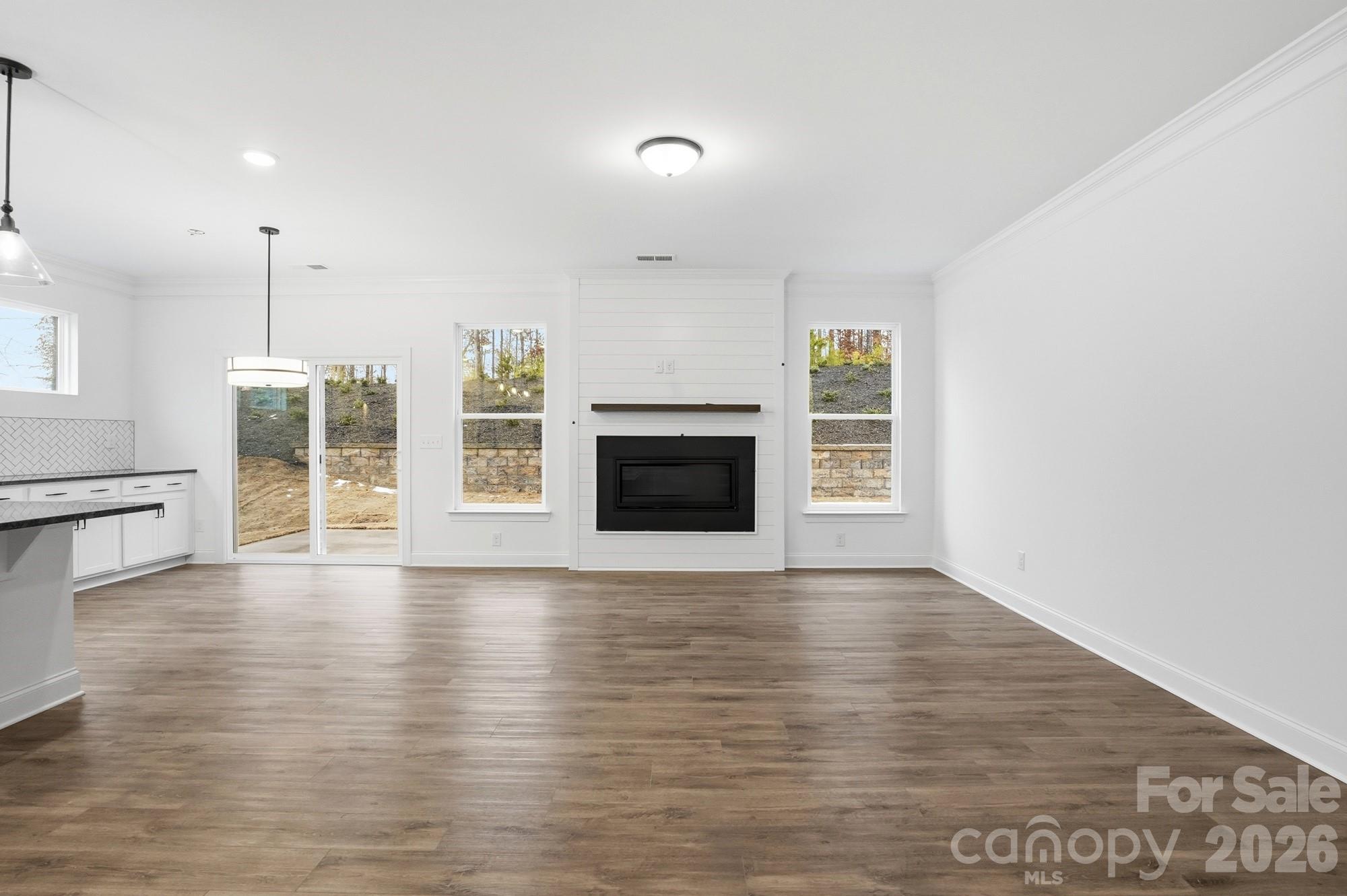5072 Mclaughlin Loop Waxhaw, NC 28173 - Photo 5 of 46 an empty room with wooden floor and fireplace