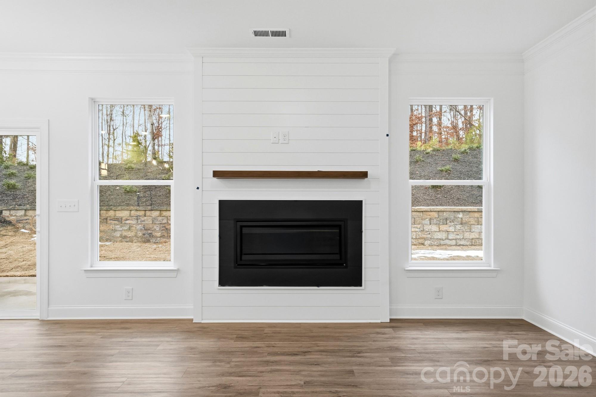 5072 Mclaughlin Loop Waxhaw, NC 28173 - Photo 9 of 46 a view of an empty room with wooden floor and a window