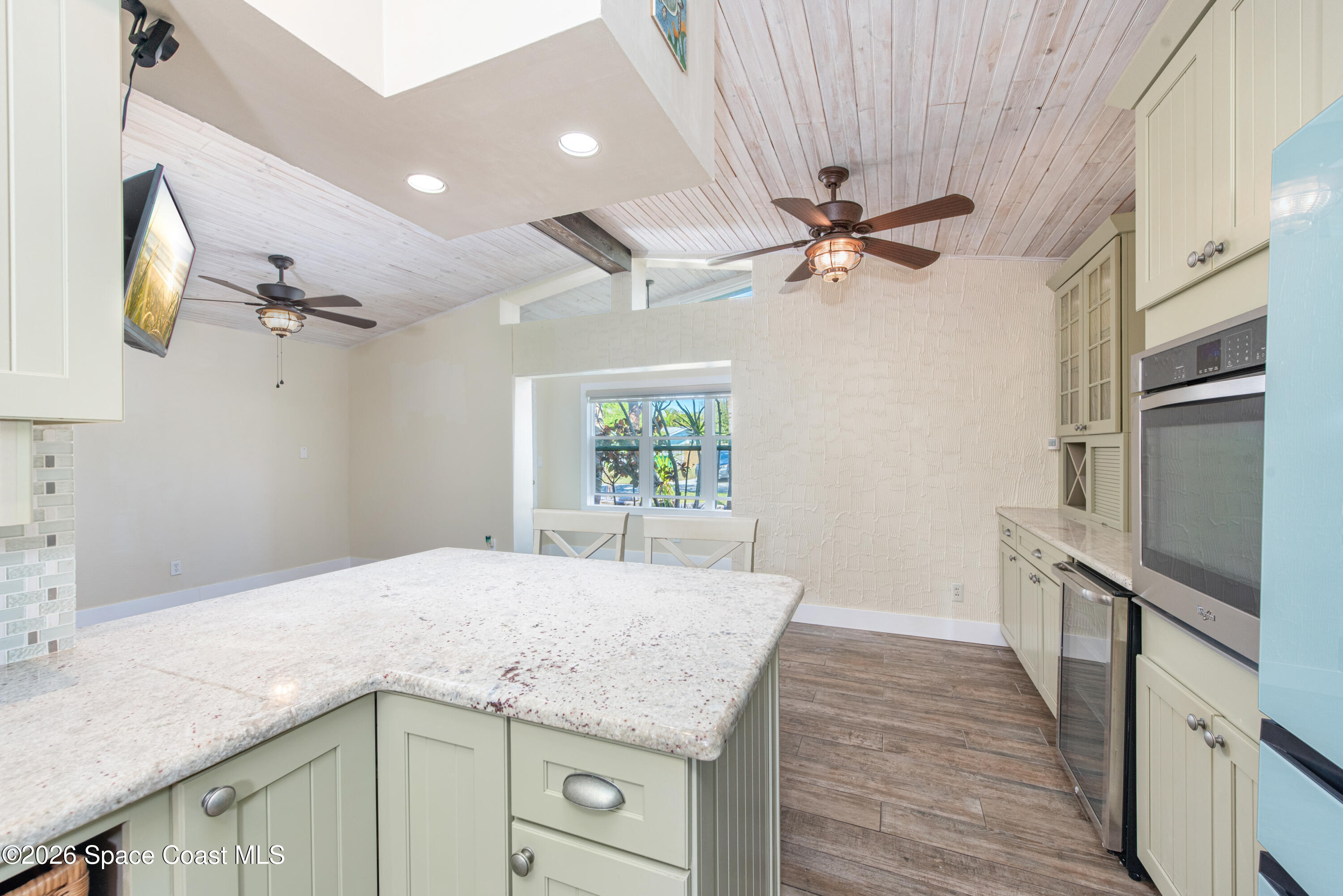 331 Avenida Del Sol Indialantic, FL 32903 - Photo 13 of 51 a kitchen with a sink a refrigerator and cabinets