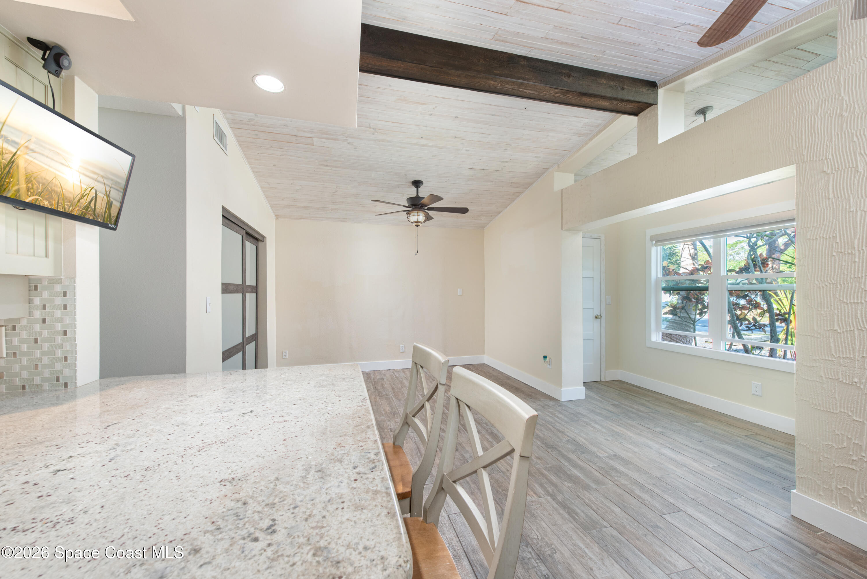 331 Avenida Del Sol Indialantic, FL 32903 - Photo 15 of 51 a view of a livingroom with wooden floor and a ceiling fan
