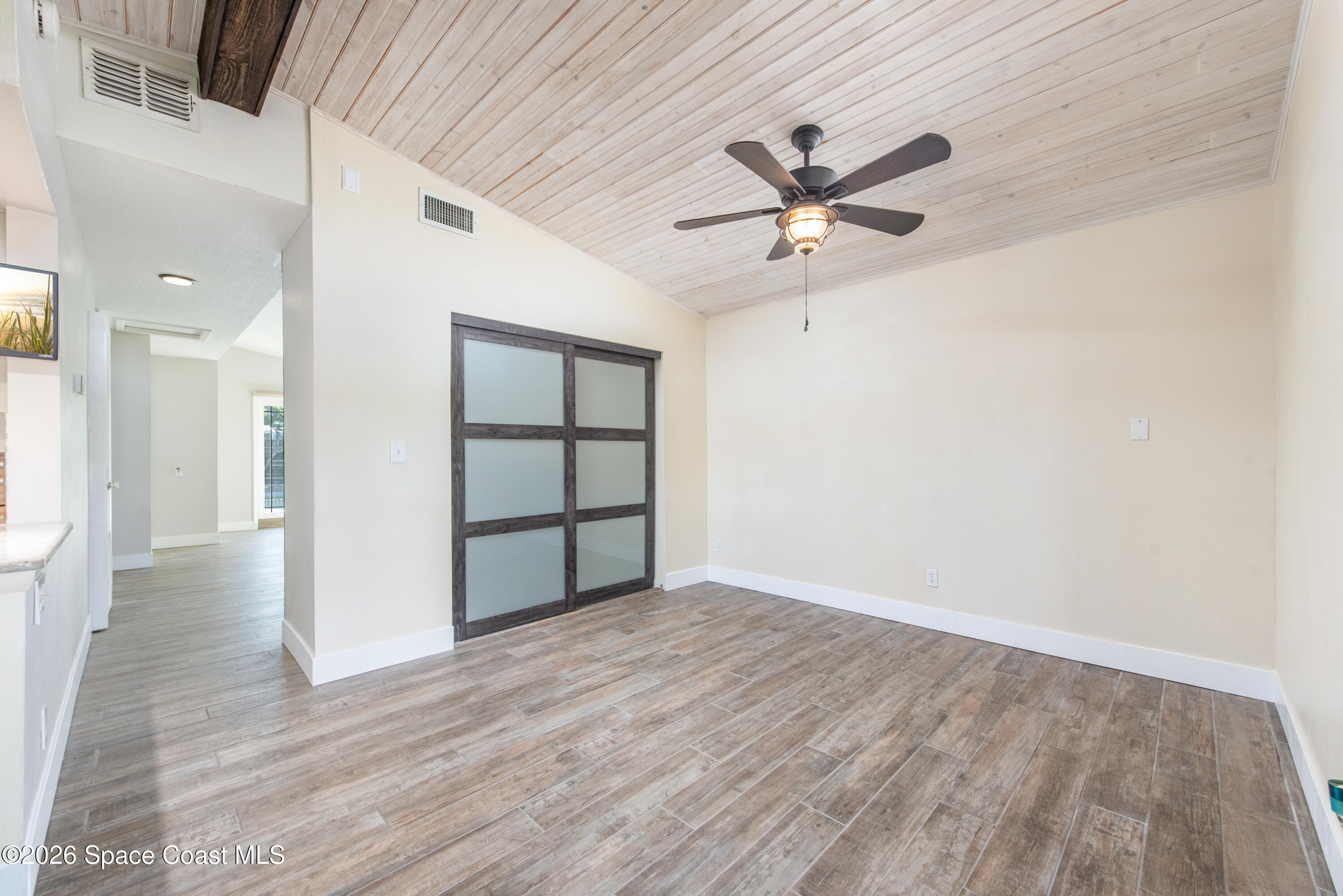 331 Avenida Del Sol Indialantic, FL 32903 - Photo 19 of 51 a view of empty room with wooden floor and fan