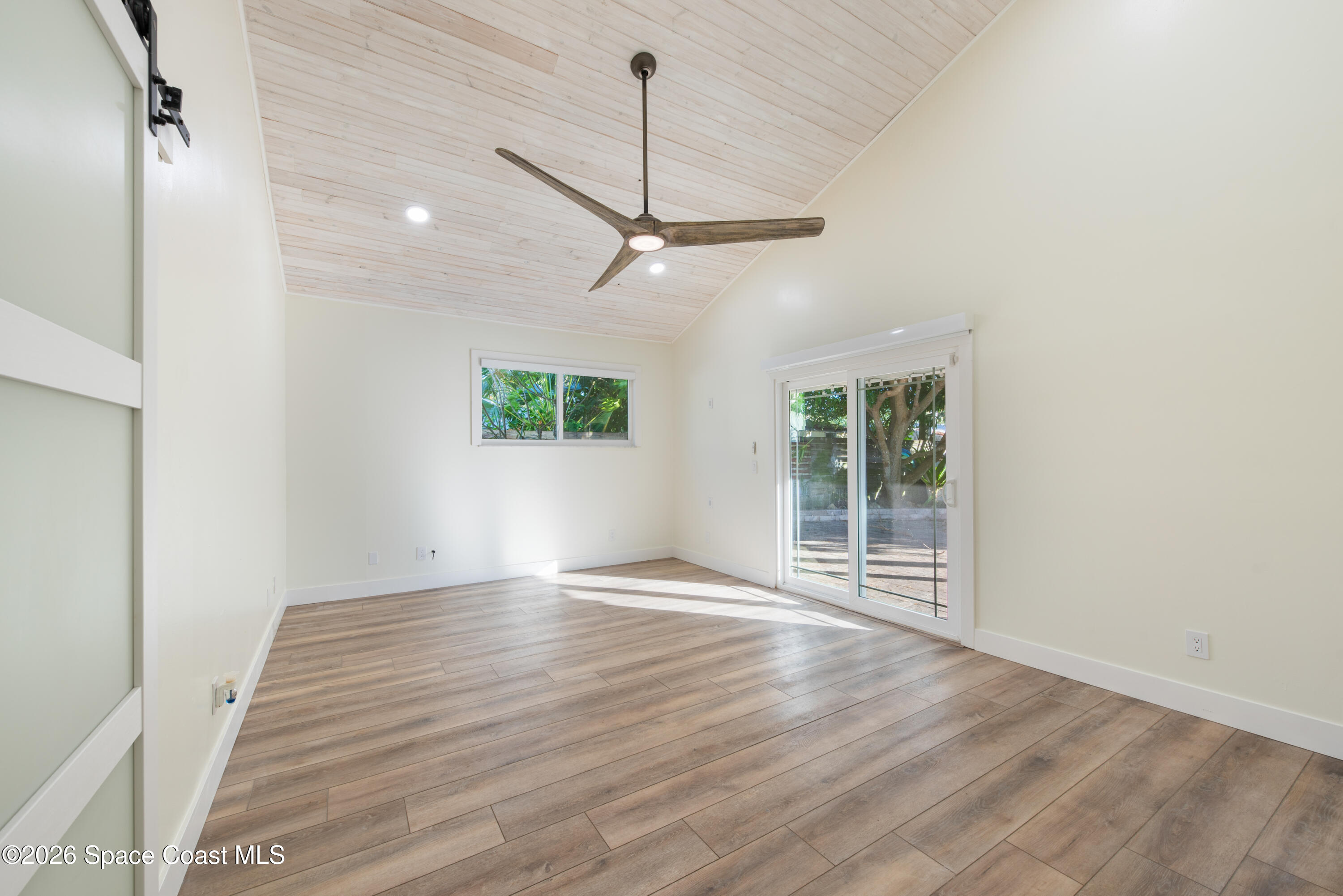 331 Avenida Del Sol Indialantic, FL 32903 - Photo 27 of 51 a view of an empty room with wooden floor and a window