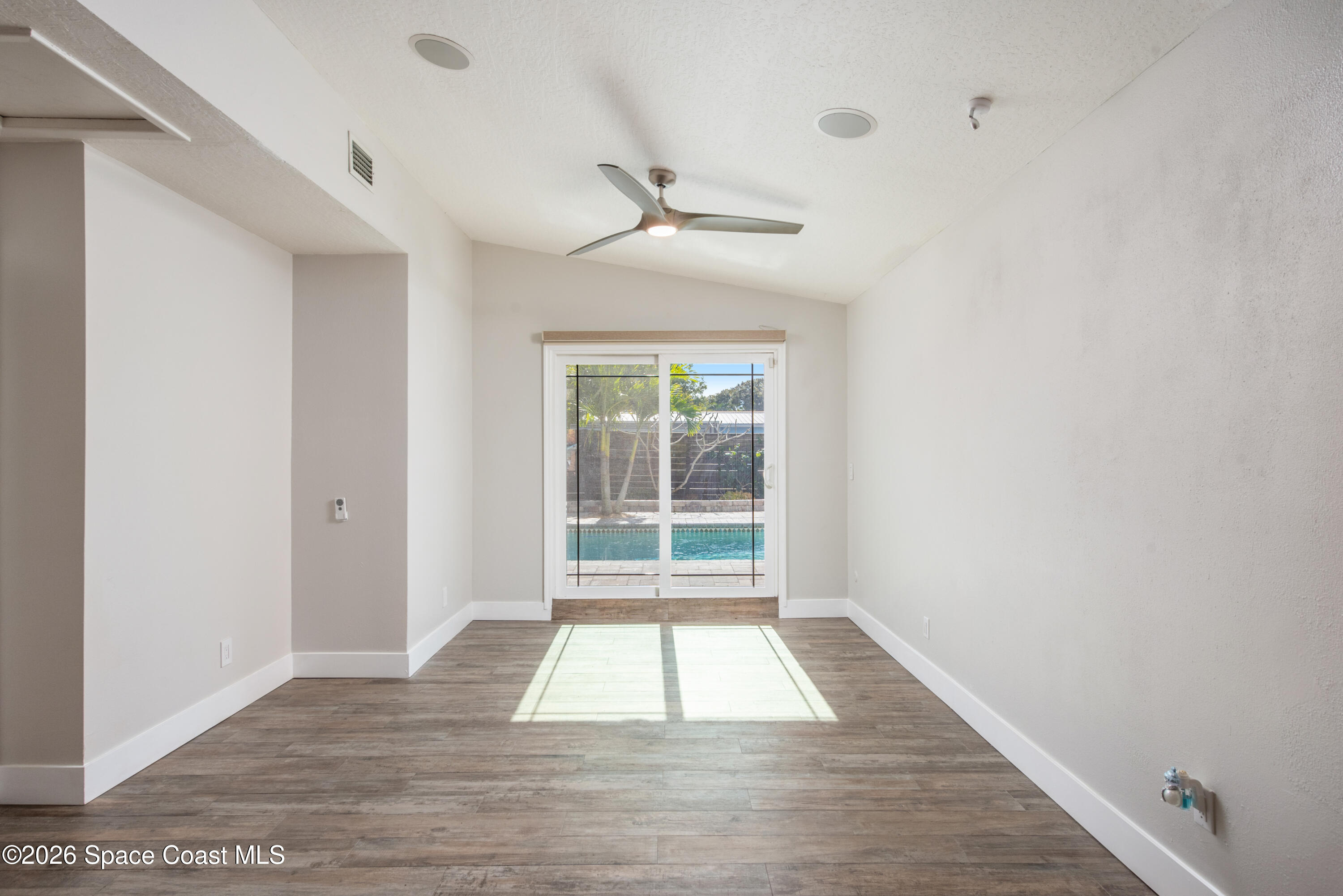 331 Avenida Del Sol Indialantic, FL 32903 - Photo 29 of 51 a view of an empty room with wooden floor and a window