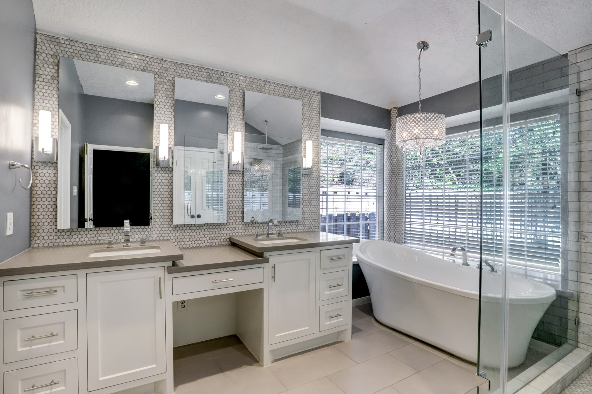 138 Summer Storm Place Spring, TX 77381 - Photo 14 of 20 Renovated primary bath featuring dual vanities, a dedicated makeup area, freestanding soaking tub and frameless glass shower.