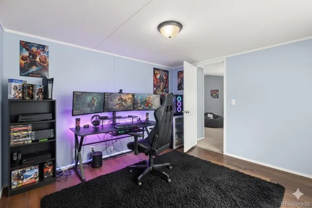 a view of an empty room with wooden floor