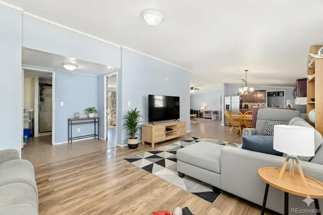 a living room with furniture and kitchen view