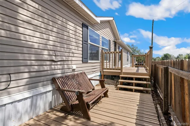 a backyard of a house with plants and a patio
