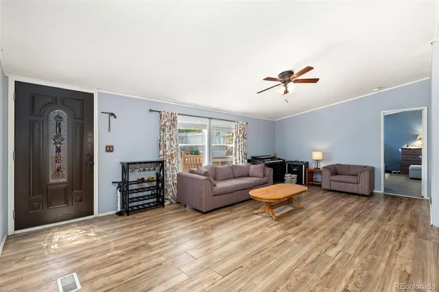 a living room with furniture a lamp and a window