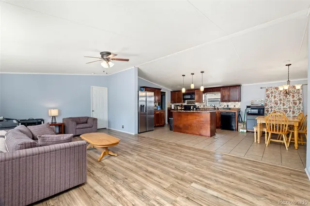 a living room with furniture and kitchen view