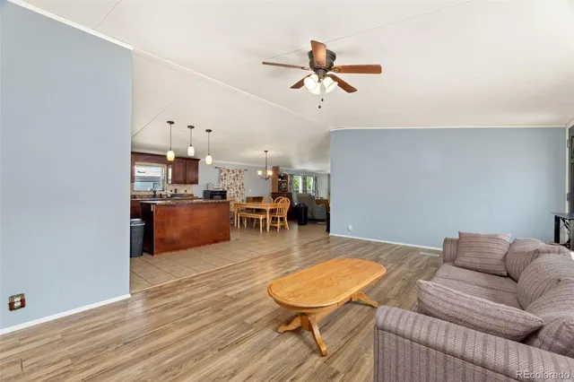 a living room with furniture and kitchen view