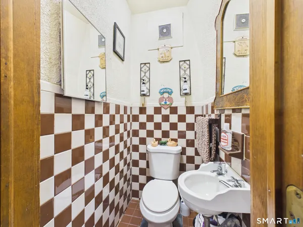 a kitchen with stainless steel appliances granite countertop a stove a sink dishwasher and a microwave oven with large cabinets