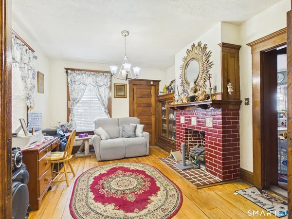 a living room with fireplace furniture and a flat screen tv