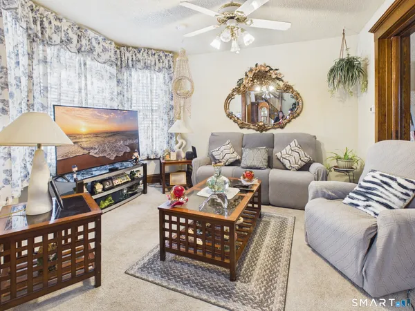 a kitchen with stainless steel appliances kitchen island granite countertop a refrigerator and a stove top oven