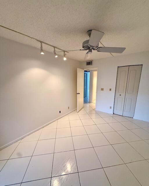 1043 Newcastle A Boca Raton, FL 33434 - Photo 11 of 17 a view of a livingroom with a ceiling fan and entryway