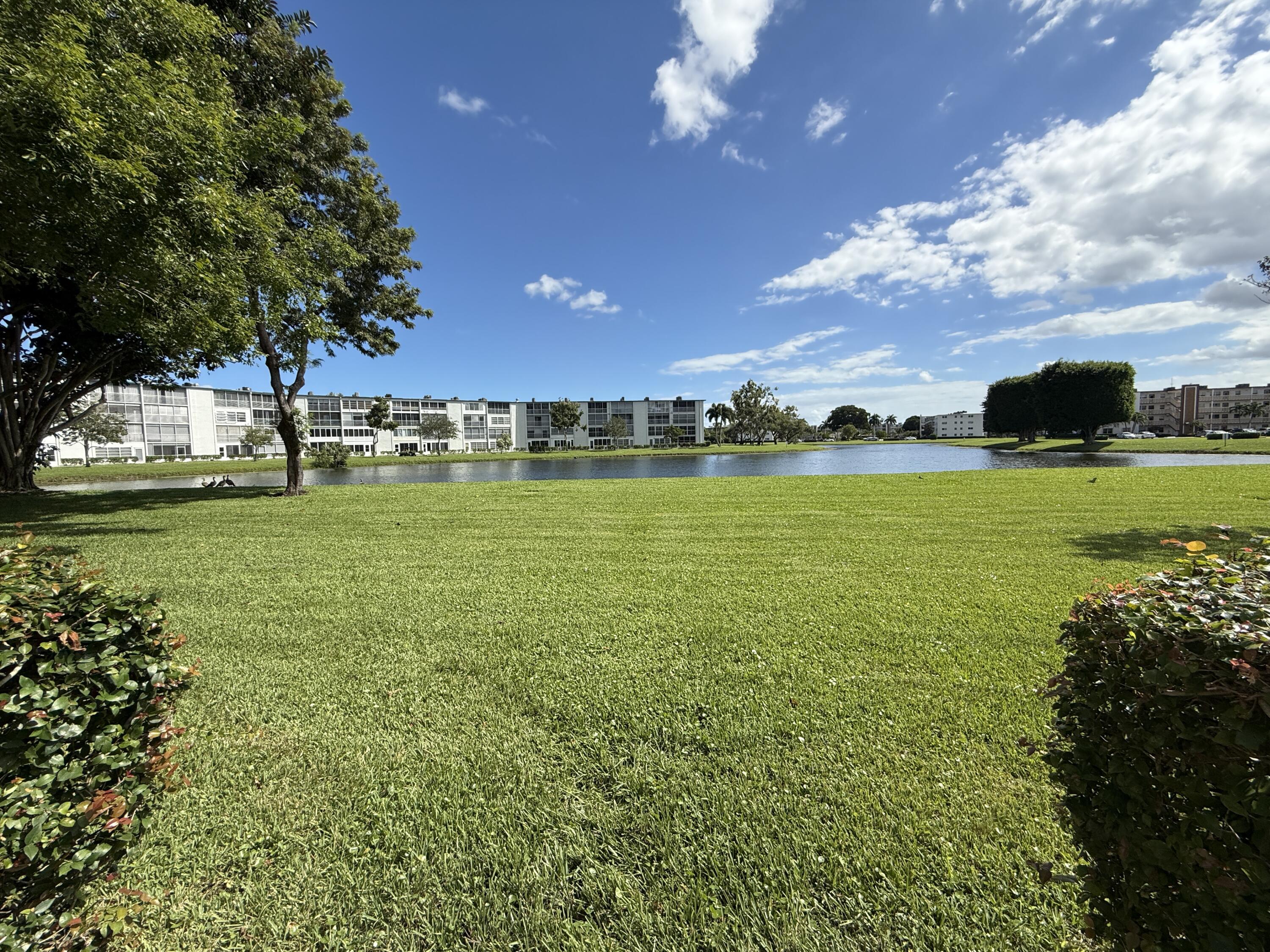 1043 Newcastle A Boca Raton, FL 33434 - Photo 16 of 17 a view of a building in the big yard
