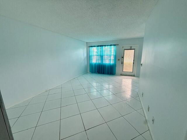 1043 Newcastle A Boca Raton, FL 33434 - Photo 7 of 17 a view of an empty room and window