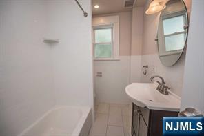 310 Union Street Carlstadt, NJ 07072 - Photo 11 of 24 a bathroom with a sink and a mirror